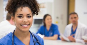 Female physician assistant and medical colleagues in a hospital setting.