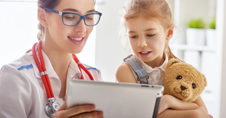 A physician assistant helping a child