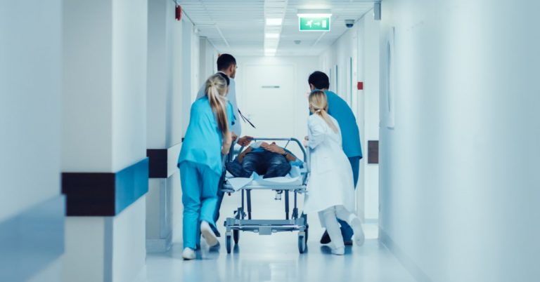 PA students in their emergency medicine rotation wheeling a patient to the emergency room